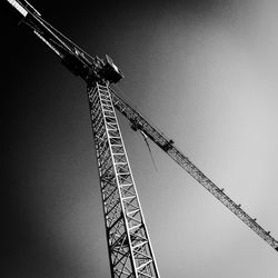 Low angle view of crane against clear sky