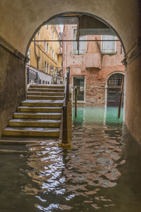 Arch bridge over canal in old building