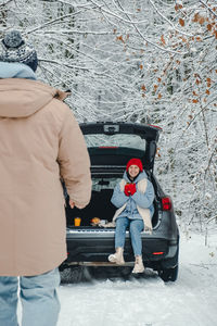 Rear view of man walking on snow