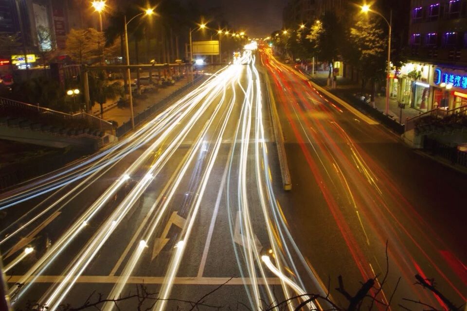 illuminated, night, transportation, city, light trail, building exterior, road, traffic, high angle view, architecture, street, built structure, street light, the way forward, long exposure, city life, land vehicle, city street, mode of transport, car