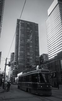 View of city buildings against clear sky