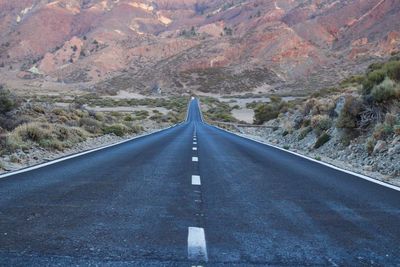 Road amidst mountains against sky