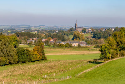 Scenic view of trees and buildings against sky