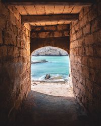 View of built structure by sea