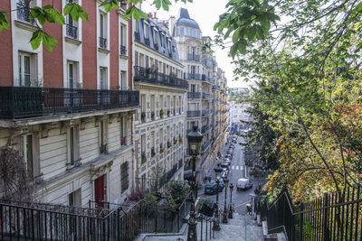 Low angle view of buildings and trees in city