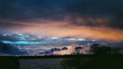 Scenic view of lake against sky at night