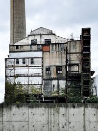 Low angle view of abandoned building against sky