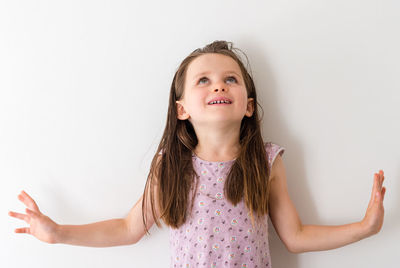 Portrait of smiling girl against white background