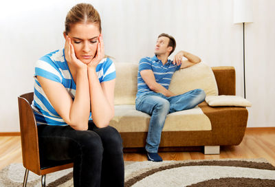 Tensed couple sitting at home