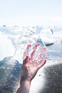 Cropped hand holding ice