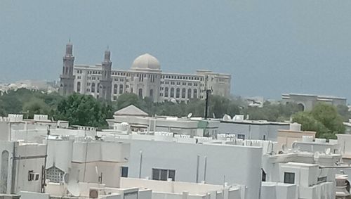 Buildings in city against clear sky