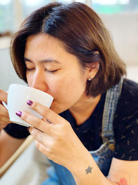 Close-up of woman drinking coffee