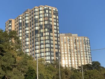 Low angle view of modern building against clear blue sky