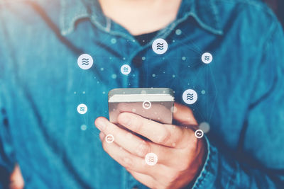 Midsection of woman using mobile phone
