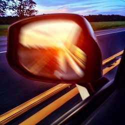 Reflection of sky in side-view mirror