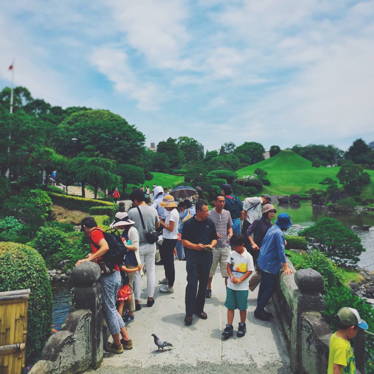 lifestyles, men, leisure activity, person, large group of people, sky, tree, togetherness, casual clothing, cloud - sky, mixed age range, walking, rear view, vacations, cloud, day, full length, outdoors, travel