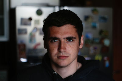 Portrait young man indoors background. serious young man with blue eyes. 20s years. handsome man