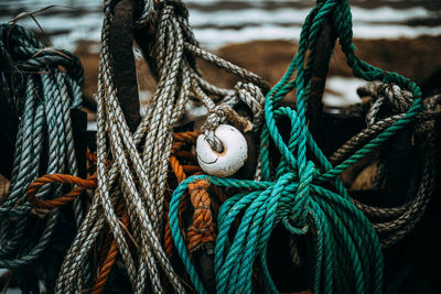 Close-up of buoys hanging at harbor