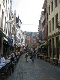 People on street amidst buildings in city