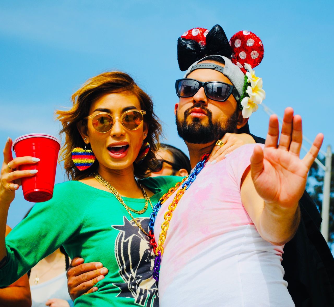 glasses, leisure activity, sunglasses, smiling, lifestyles, young adult, real people, fashion, young men, portrait, adult, happiness, sky, emotion, young women, women, two people, holding, waist up, front view, couple - relationship