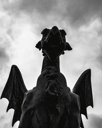 Low angle view of angel statue against sky