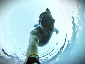 Low angle view of man swimming in sea