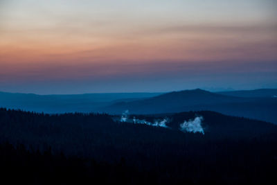 Scenic view of silhouette mountains against sky at sunset