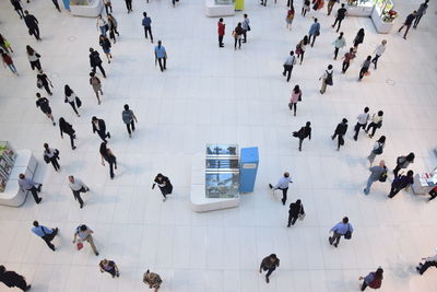 High angle view of people walking on tiled floor