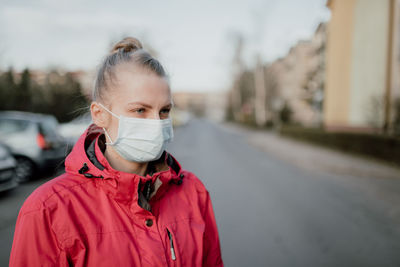 Portrait of woman standing on road in city