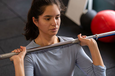 Portrait of young woman exercising in gym