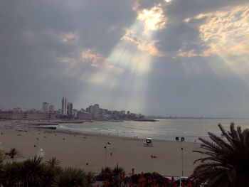 Panoramic view of sea and buildings against sky