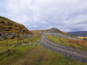 Panoramic view of road amidst landscape against sky