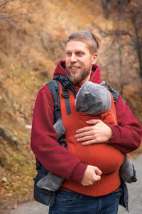 Portrait of senior man sitting on rock