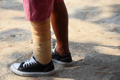 Low section of person standing on street