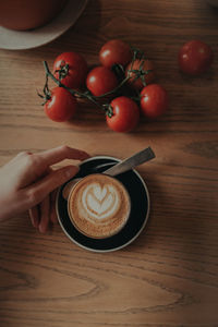 Man holding coffee cup on table