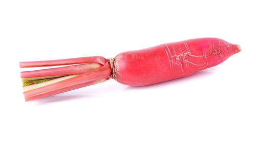 Close-up of red chili peppers over white background