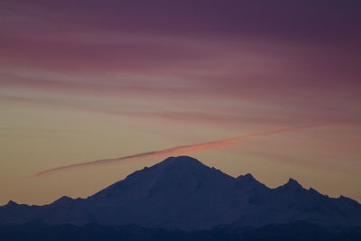Scenic view of mountains against sky at sunset