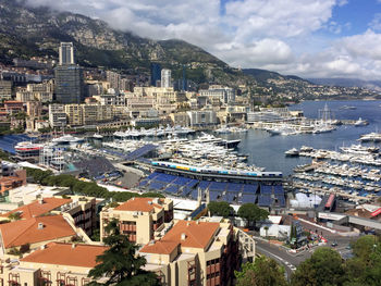 High angle view of townscape by sea against sky