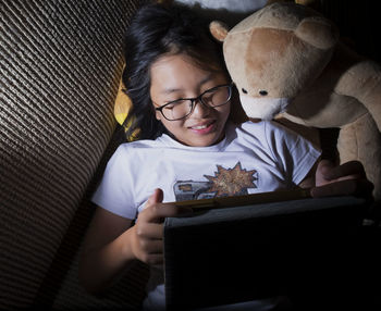 Close-up of girl using tablet at home