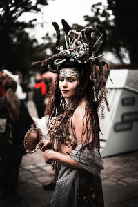 Portrait of young woman standing in traditional clothing