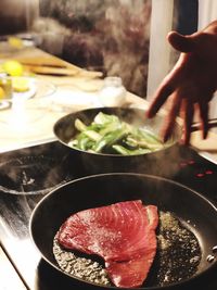 Close-up of person preparing food on table