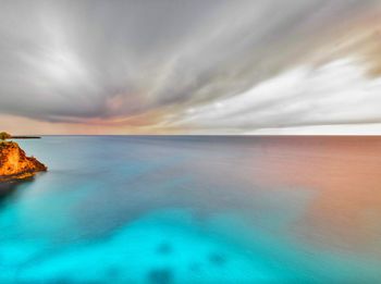 Scenic view of sea against cloudy sky