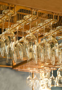 Low angle view of empty wineglasses in rack