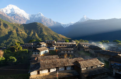 Buildings against mountain range
