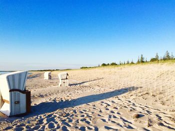 View of beach against clear blue sky