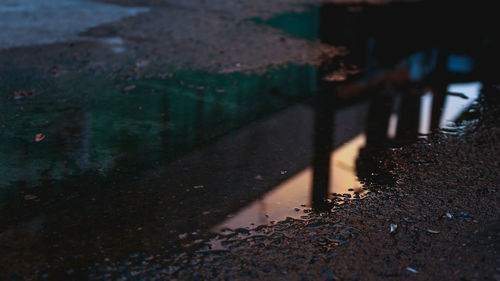 Reflection in puddle at dusk during monsoon