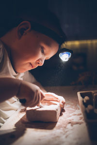 The boy plays the game young archaeologist at home.