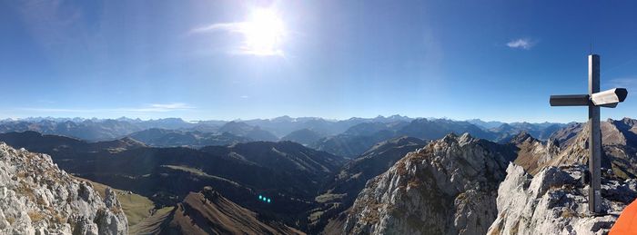 Panoramic view of mountains against blue sky