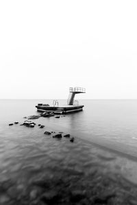 Ship in sea against clear sky