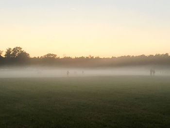 Scenic view of field against sky during sunset